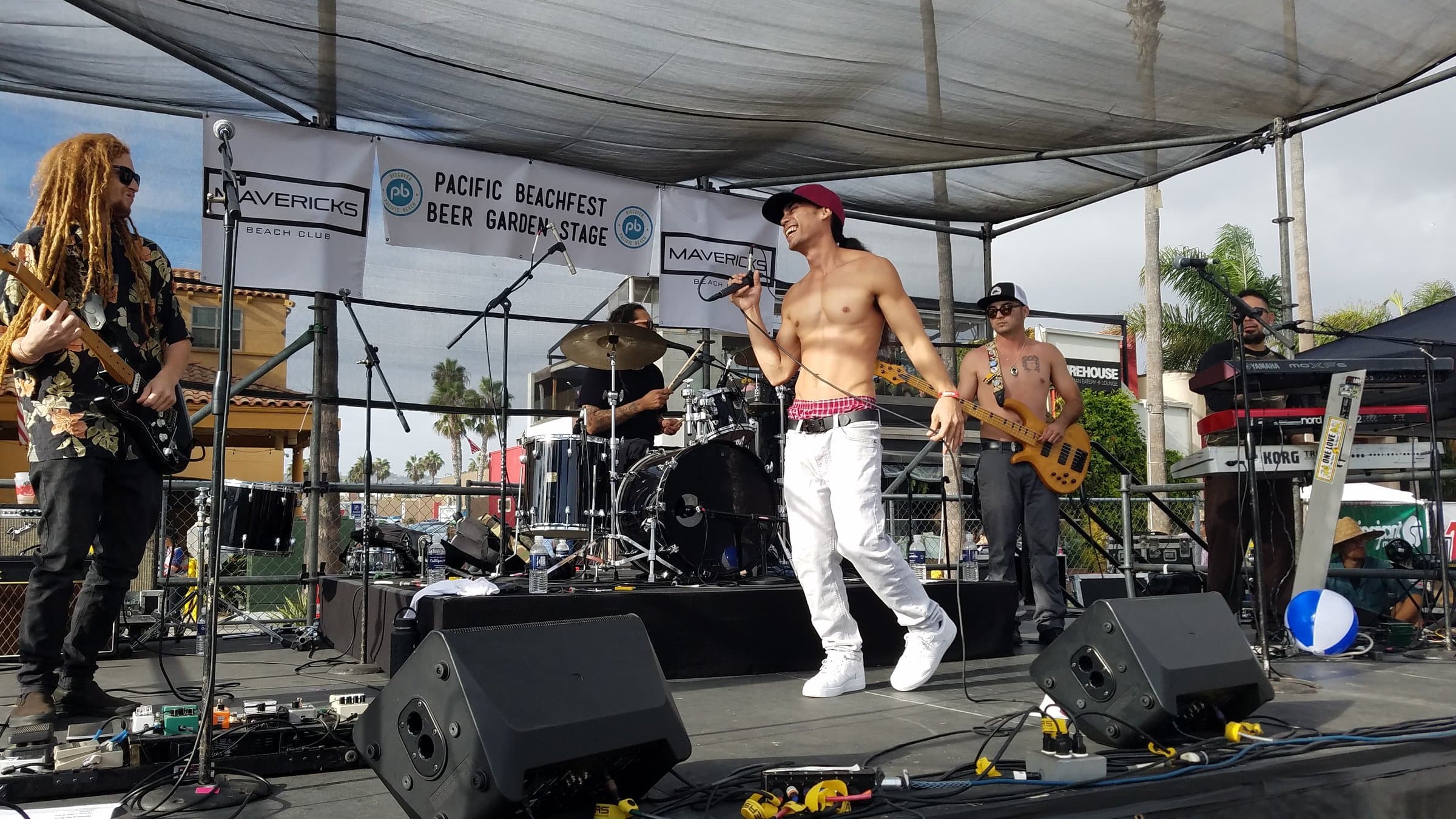Kekoa performing with his band on an outdoor stage